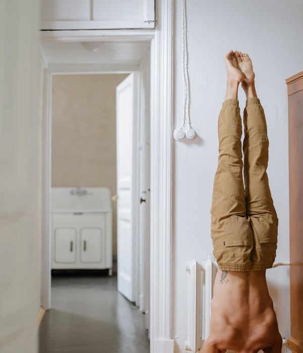 Man stretching his lower back in a calm, focused environment.